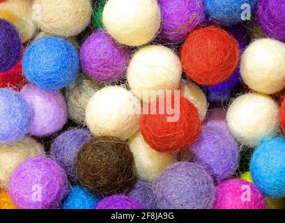 background of felt balls for sale as christmas decorations Stock Photo