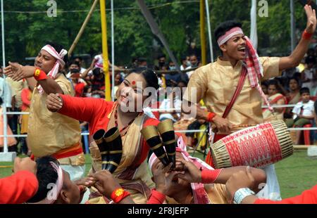 Guwahati. 14th Apr, 2021. People perform Bihu, a folk dance, during the Rangoli Bihu Festival in Guwahati city of India's northeastern state of Assam on April 14, 2021. Credit: Str/Xinhua/Alamy Live News Stock Photo