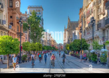 SEVILLA, SPAIN, JUNE 25, 2019: People are strolling on a street in Sevilla, Spain Stock Photo