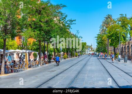 SEVILLA, SPAIN, JUNE 25, 2019: People are strolling on a street in Sevilla, Spain Stock Photo