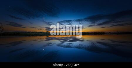 A beautiful and peaceful twilight in the Florida Everglades with a crescent moon and stars. Stock Photo