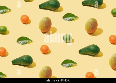 Background pattern with fresh fruit and green leaf layout on pas Stock Photo