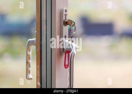 Close up view of key in keyhole of open door. Sweden. Stock Photo