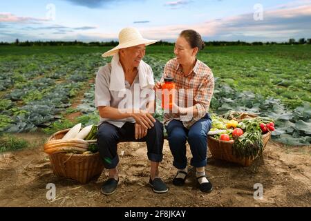 Peasant couple sitting in on-farm water Stock Photo