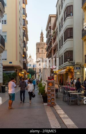 VALENCIA, SPAIN, JUNE 17, 2019: Narrow street leading to Torre del Micalet bell tower of the cathedral of Valencia, Spain Stock Photo