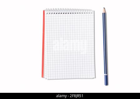 directly above view of small spiral notepad and pencil isolated on white background Stock Photo