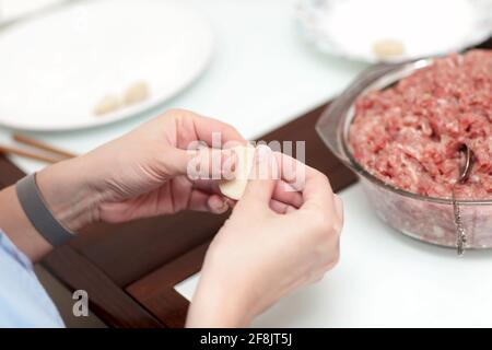 The woman is cooking dumplings at home Stock Photo