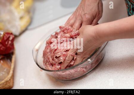 A cook mixing mince for the dumplings at home Stock Photo