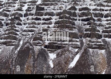 Talus cones and scree, stony deposits at base of mountain slope in winter at Snaefellsnes, western Iceland Stock Photo