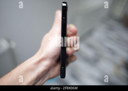 BRCKO, BOSNIA AND HERZEGOVINA - Oct 15, 2020: Man holding black Apple iPhone in left hand Stock Photo