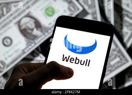 China. 27th Mar, 2021. In this photo illustration, the financial services company Webull logo is seen on an Android mobile device screen with the currency of the United States dollar icon, $ icon symbol in the background. Credit: Chukrut Budrul/SOPA Images/ZUMA Wire/Alamy Live News Stock Photo