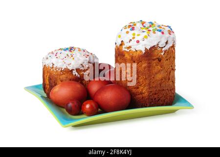 Festive easter cakes and painted eggs on a platter isolated on white background Stock Photo
