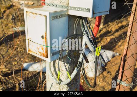 Junction box for connecting electrical wires. Attached to the lamppost. Close-up Stock Photo