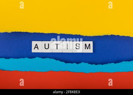 World Autism Awareness background. Ripped paper edge with inscription Autism background. Flat lay. Copy space. Stock Photo