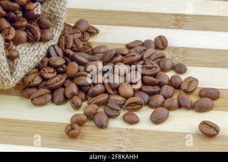 Coffee beans on burlap sac bag on desk with place for you text. Stock Photo