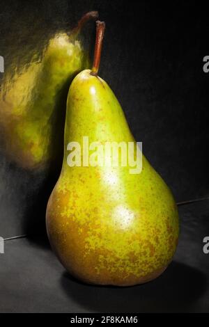 mirrored green pear on black background Stock Photo