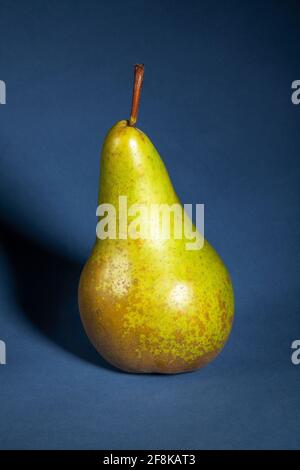 green pear on blue background Stock Photo