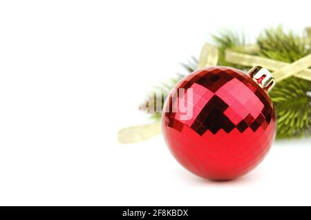 Christmas ball on the background of fir tree with golden ribbon Stock Photo