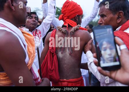 Guwahati, Assam, India. 14th Apr, 2021. Hindu devotee pierced with iron hook, during Charak Puja festival amid COVID-19 Coronavirus pandemic at a village in Barpeta district of Assam. Charak Puja is a Hindu folk festival in honour of the god Shiva. It's held in Indian state of West Bengal and southern Bangladesh on the last day of the month of Chaitra, at midnight. Credit: David Talukdar/ZUMA Wire/Alamy Live News Stock Photo