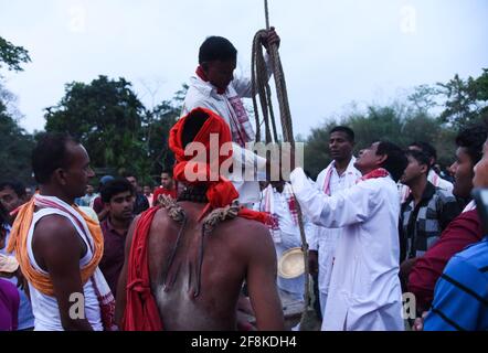 Guwahati, Assam, India. 14th Apr, 2021. Hindu devotee pierced with iron hook, during Charak Puja festival amid COVID-19 Coronavirus pandemic at a village in Barpeta district of Assam. Charak Puja is a Hindu folk festival in honour of the god Shiva. It's held in Indian state of West Bengal and southern Bangladesh on the last day of the month of Chaitra, at midnight. Credit: David Talukdar/ZUMA Wire/Alamy Live News Stock Photo