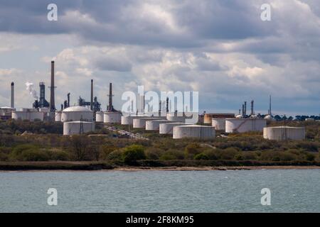 tanks and chimneys at the esso fawley exon mobil petrochemical oil refinery depot on southampton water uk Stock Photo