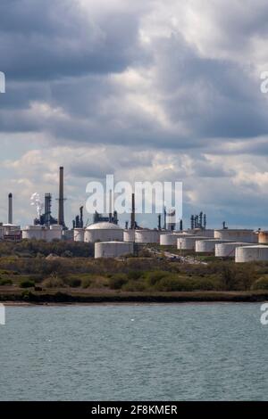 tanks and chimneys at the esso fawley exon mobil petrochemical oil refinery depot on southampton water uk Stock Photo