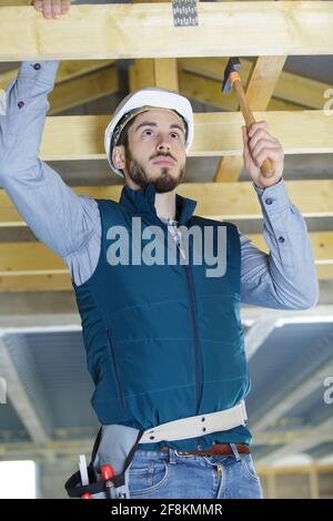 roofer builder working on roof structure Stock Photo