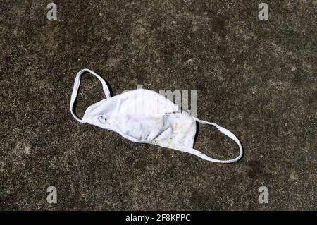 Horizontal shot of a dirty child's face mask discarded Stock Photo
