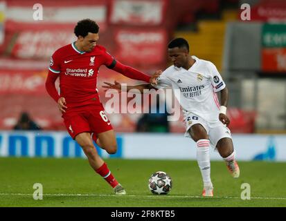 Liverpool, England, 14th April 2021. Trent Alexander-Arnold of Liverpool tackles Vinícius Júnior of Real Madrid during the UEFA Champions League match at Anfield, Liverpool. Picture credit should read: Darren Staples / Sportimage Stock Photo