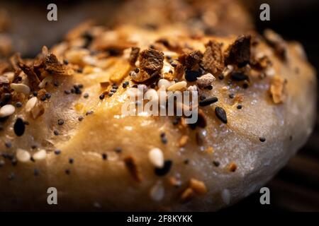Macro shot of bagel with prominent toasted everything seasoning Stock Photo