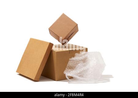 Close-up shot of different shaped cardboard boxes and bubble wrap isolated on white background Stock Photo
