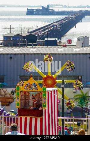 High views of Southend on Sea seafront in summer 2007. Punch and Judy in progress, Adventure Island ride and Southend Pier Stock Photo