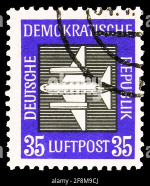MOSCOW, RUSSIA - SEPTEMBER 30, 2019: Postage stamp printed in Germany shows Plane, 35 Pf. - East German pfennig, Airmail serie, circa 1957 Stock Photo