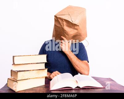 Tired and sleepy mature man on his books, studies to improve his economy. Stock Photo