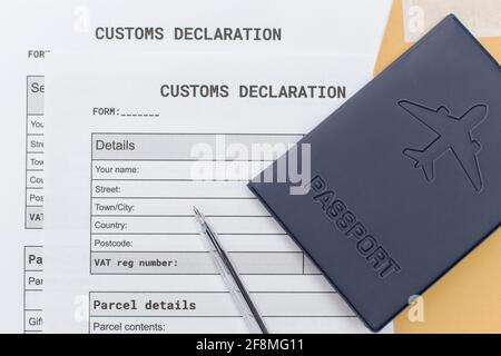 a Passport over Customs Declaration form. customs Agent concept. Planning a deal or shipping item parsel on post. Stock Photo