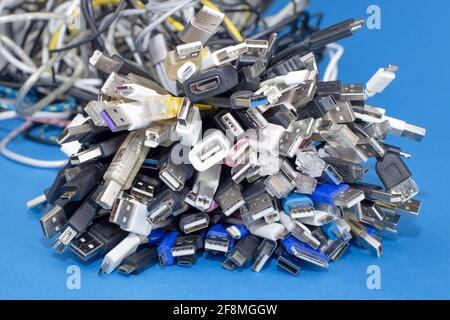 Heap a Lot Of Used USB (Universal Serial Bus) cables Connectors plugs universal standart for computer different types cables and Ports peripheral Stock Photo