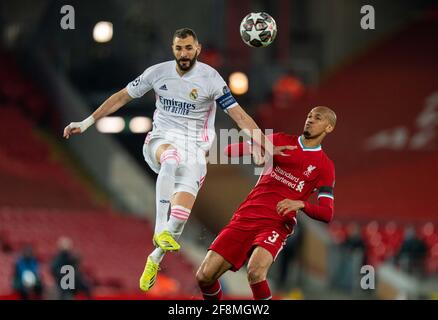 Liverpool. 15th Apr, 2021. Real Madrid's Karim Benzema (L) is challenged by Liverpool's Fabinho during the UEFA Champions League quarterfinal 2nd Leg match between Liverpool and Real Madrid at Anfield in Liverpool, Britain, on April 14, 2021. Credit: Xinhua/Alamy Live News Stock Photo