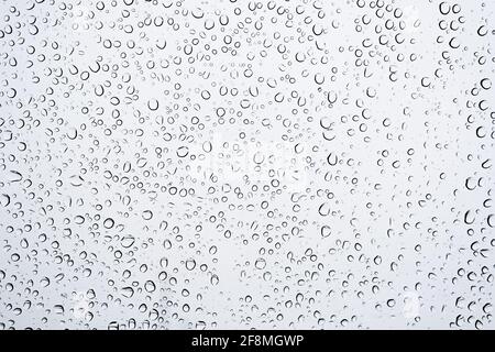 Close up Water Drops on window Glass on a autumn rainy day. rain Wet weather  Background Stock Photo