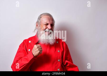 Retired American male with red western bib shirt making a fist with an angry look Stock Photo