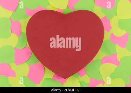 Red heart shape with texture on Neon  sticky notes in heart form shape over blue background. Love in Valentine's Day Date concept Stock Photo