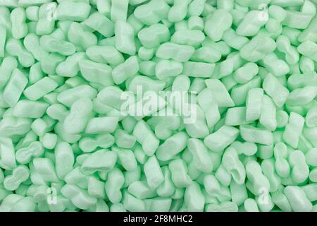 Green Polystyrene Foam Peanuts Packaging Filler Cushioning Material Texture Background Stock Photo