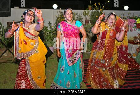 Beawar, India. 14th Apr, 2021. Rajasthani women dance as they celebrate Sinjara on the eve of Gangaur Teej festival in Beawar. During the Gangaur festival, married women and unmarried girls worship the Hindu goddess Gauri, consort of the Lord Shiva. (Photo by Sumit Saraswat/Pacific Press) Credit: Pacific Press Media Production Corp./Alamy Live News Stock Photo
