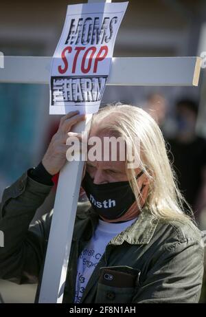 Vancouver, Canada. 14th Apr, 2021. A participant carries a wooden cross while attending the rally of the five-year anniversary of declared overdose crisis a public health emergency in Vancouver, British Columbia, Canada, April 14, 2021. Family members and friends of the victims who died from drug overdose took part in a rally to mark the five-year anniversary of British Columbia declared overdose crisis a public health emergency. Credit: Liang Sen/Xinhua/Alamy Live News Stock Photo