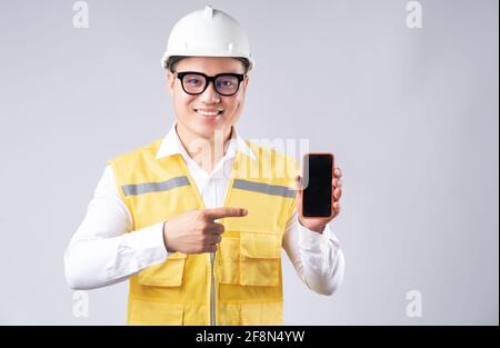 The Asian engineer was pointing at the phone screen Stock Photo