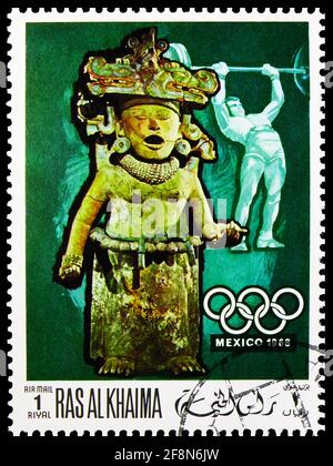 MOSCOW, RUSSIA - OCTOBER 4, 2019: Postage stamp printed in Ras Al Khaimah shows Weightlifting, pre-columbian sculpture, Summer Olympics 1968, Mexico s Stock Photo