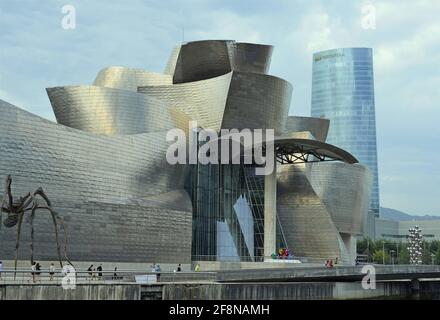 Museum Guggenheim Bilbao on the banks of the Ria de Bilbao or Nervion River Spain Stock Photo
