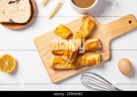 Closeup of ingredients in making bread and freshly baked breads on a chopping board Stock Photo