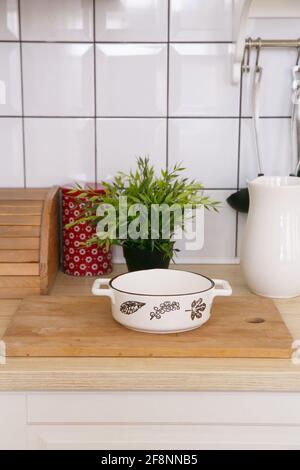 White empty ceramic baking dish in a light scandinavian kitchen in the morning Stock Photo