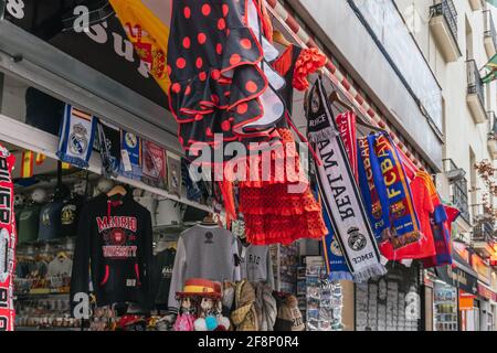 MADRID, SPAIN - Mar 25, 2021: Madrid souvenir shop with flamenco dresses and scarves from the Barcelona and Real Madrid historic clubs Stock Photo