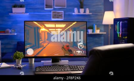 Close-up of empty gaming studio equipped during first person shooter online competition. Streaming studio with professional setup with powerful computer ready for online championship Stock Photo
